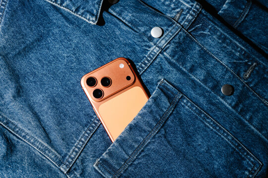 Copper Colored Smartphone In Denim Jacket Pocket