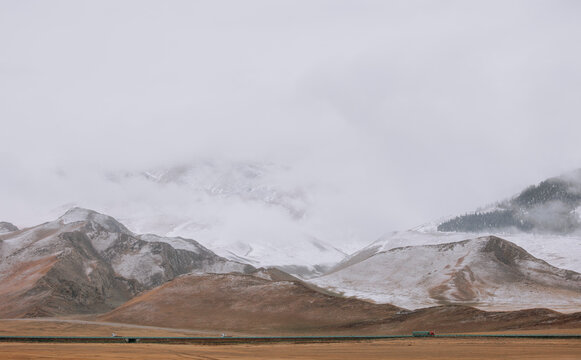 A Highway Spanning High-Altitude Snow Mountains and Wilderness.