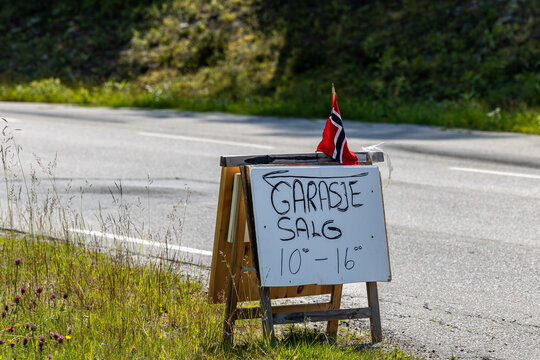 Drevsjo, Norway A sign in Norwegian on a road with a Norwegian flag advertises a rummage sale, or garage sale
