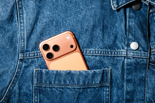 Copper Colored Smartphone In Denim Jacket Pocket