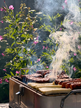 Summer BBQ Food Cooking In Blooming Garden