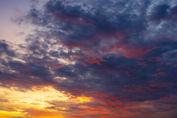 Fototapeta premium Beautiful Colorful Sunset Sky with Dramatic Clouds,A breathtaking view of a vibrant sunset sky filled with dramatic clouds, showcasing a stunning gradient of purple, orange, and blue hues.