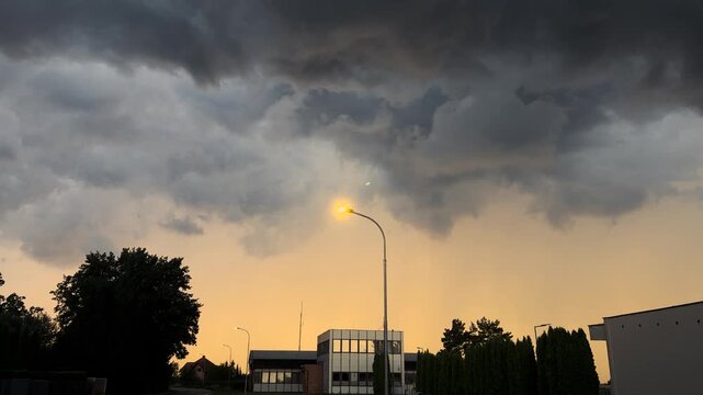 Camera Tilt Up from Village Street to Dramatic Storm Clouds in Sky