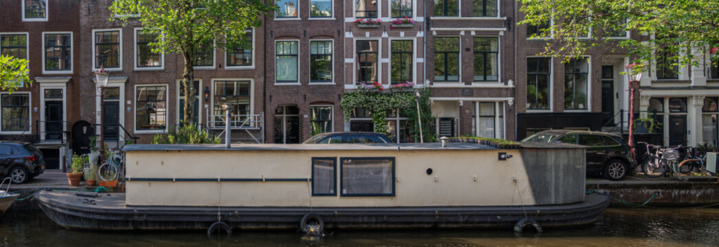 Traditional Dutch houseboat on Bloemgracht canal in Amsterdam&rsquo;s Jordaan district in Amsterdam, Netherlands 06.17.2026