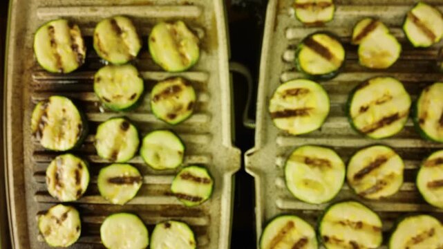 Grilling zucchini slices on an electric grill with distinct char marks