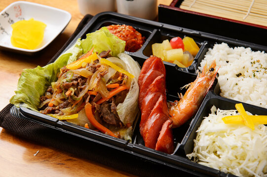 Korean lunch box dosirak with rice sausage and side dishes
