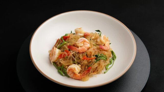 Stir Fried Glass Noodle with Water Mimosa and shrimp in white plate.Thai food.