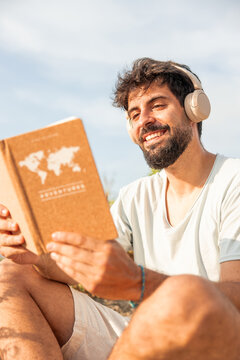 Man enjoying digital detox, reading adventure book outdoors