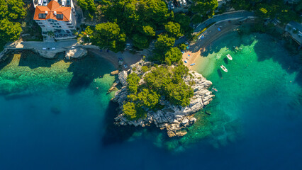Top-down aerial view of Medvidina cave cliff and turquoise bay in Brela, Croatia © Light&Lens