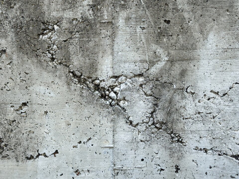 Raw shuttered concrete wall texture background. Exposed aggregate honeycomb defect on grey cement surface. Distressed industrial grunge concrete backdrop.