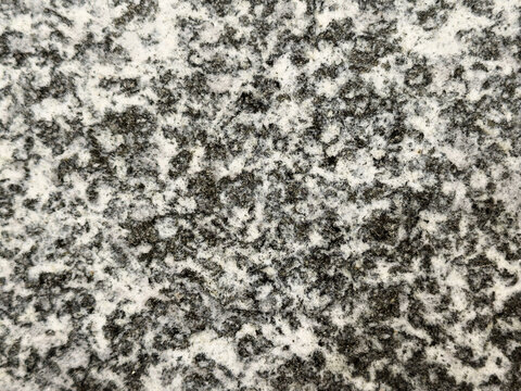 Black and white granite texture background. Polished speckled diorite stone pattern. Natural igneous rock surface with mineral grain backdrop.