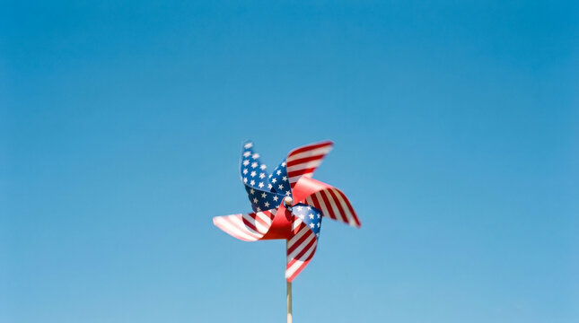 American flag pinwheel spinning against blue sky