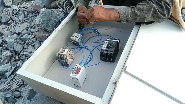  Electrician at work, Electrician Hands Wiring Components Inside an Industrial Control Panel Box