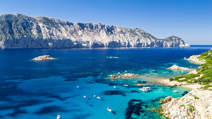 Fototapeta premium Aerial view of Tavolara Island seen from Molara Island across crystal-clear turquoise waters in the Tavolara Marine Protected Area, Sardinia, Italy