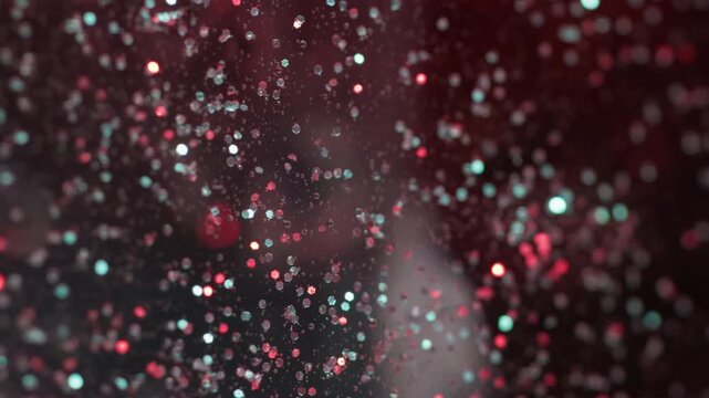 Shiny bokeh light. Sparkling spill. Red blue color round circles sequin particles flow abstract art background.