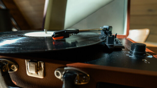 Close-up of a vintage record player needle on a spinning vinyl disc