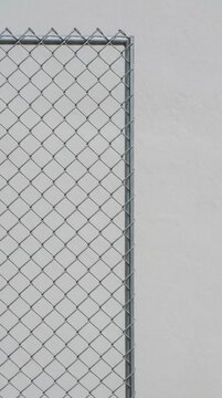 Chain link fence against a plain wall