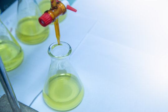 Burette filled with yellow liquid in laboratory.