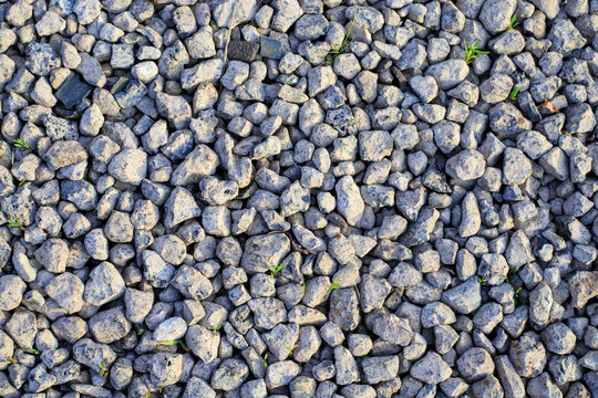 Gray granite gravel texture. Industrial aggregate for durable road foundations, drainage systems, and professional landscaping