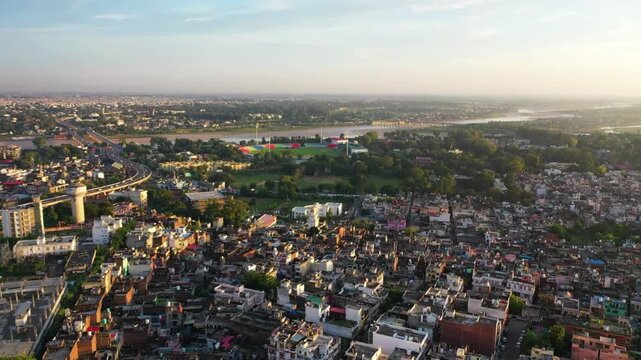 Cinematic aerial view of Jammu City and MA Stadium during golden hour.