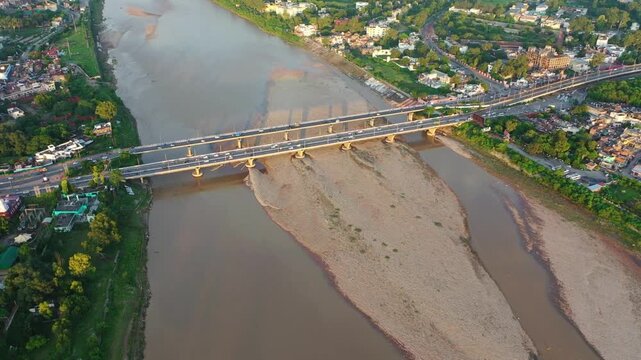Drone shot of Vikram Chowk bridges and Jammu cityscape during golden hour.