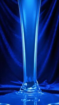 Abstract Blue Liquid Flowing in Elegant Glassware.