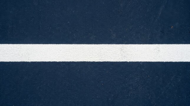 Minimalist blue asphalt background with white painted line, textured sports court surface, abstract horizontal stripe on dark navy pavement
