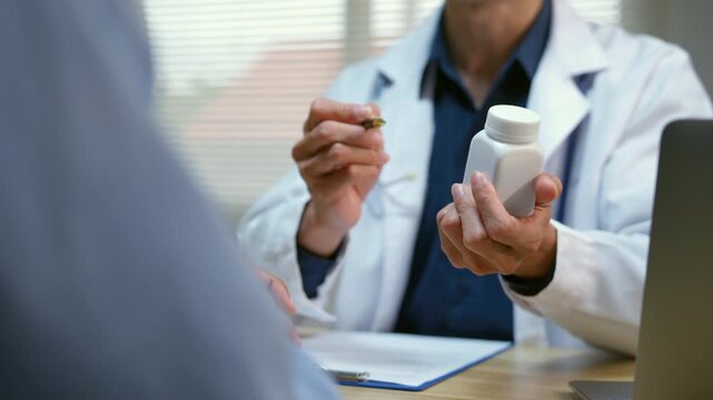 Doctor explaining prescription medication and dosage to a patient during a medical consultation in a clinic