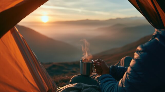 Traveler relaxing inside a camping tent with a hot cup of coffee while enjoying a mountain sunrise. Cozy outdoor lifestyle, soft morning mist and peaceful camping atmosphere.