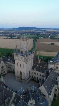 Vertical video close view of the tower of Marienburg Castle to the leading road