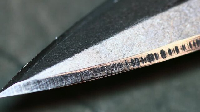 A close-up shot of a knife lying on a table, suitable for use in crime scene or kitchen setting