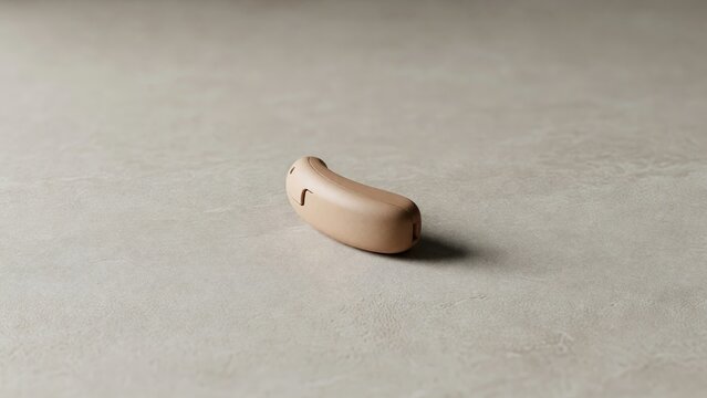 Hearing aid on a solid neutral surface. Device for disability support and sound amplification. Modern medical technology for deaf or hard of hearing patient. Clinical auditory gadget.