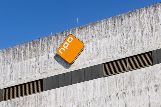 Hilversum, Netherlands - July 13, 2026: The orange diamond logo of the Nederlandse Publieke Omroep (NPO) mounted on the concrete exterior wall of a television office building at Media Park.