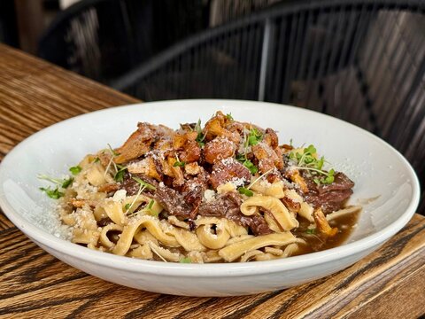 Fresh Pasta with Chanterelle Mushrooms Beef and Parmesan Cheese in Restaurant