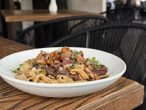 Fresh Pasta with Chanterelle Mushrooms Beef and Parmesan Cheese in Restaurant