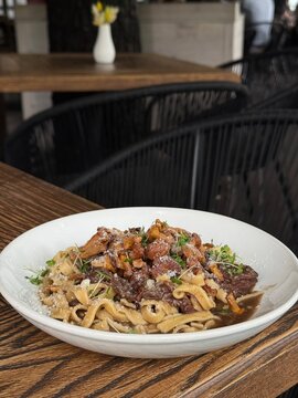 Fresh Pasta with Chanterelle Mushrooms Beef and Parmesan Cheese in Restaurant