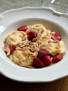 Fluffy Cottage Cheese Pancakes with Fresh Strawberries Almond Flakes and Cream Sauce