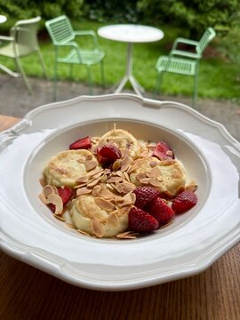 Fluffy Cottage Cheese Pancakes with Fresh Strawberries Almond Flakes and Cream Sauce