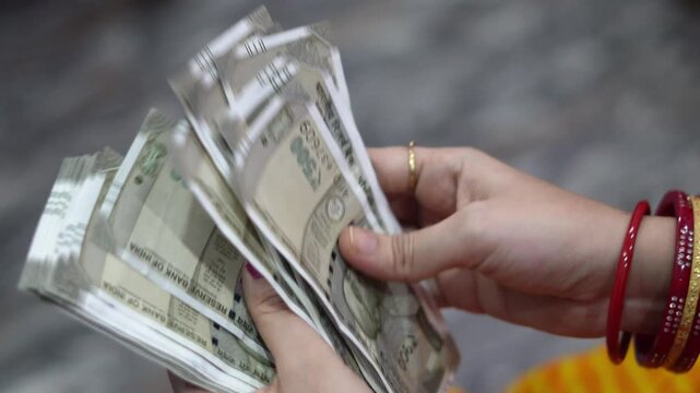 Displaying Fresh Stack of Indian 500 Rupee Banknotes Held by Woman Hands. Displaying and Counting Fresh Stack of Indian Rupee Banknotes.