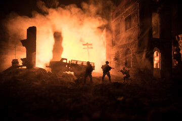 Fototapeta premium War Concept. Battle scene on war fog sky background, Fighting silhouettes Below Cloudy Skyline at night. City destroyed by war