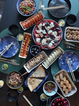 Japanese Sushi Feast with Rolls Salad and Appetizers Served on Dining Table