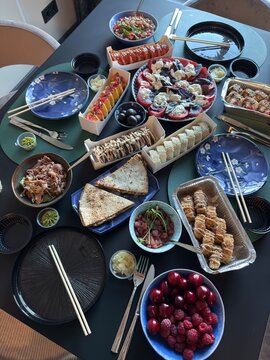 Japanese Sushi Feast with Rolls Salad and Appetizers Served on Dining Table