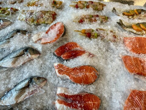Fresh Seafood Display with Salmon Fish and Ice at Fish Market