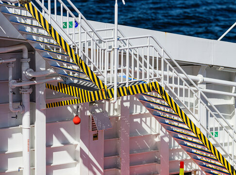 Red diamond plate metal texture on ferry deck.
