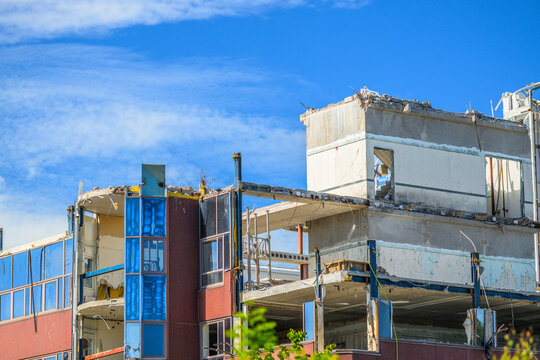 Partially demolished concrete office building with exposed upper floors.
