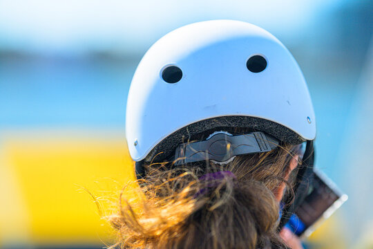 Close view of white safety helmet on outdoor rider.