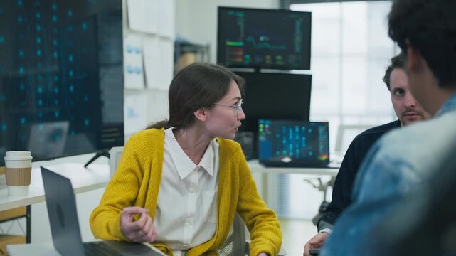 Diverse software developers analyzing UI UX design on tablet for mobile application marketing campaign creative team collaboration strategy tech hybrid workspace office background	