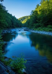 Obraz premium A serene blue river flows gently through a lush green valley during a bright afternoon, reflecting the clear sky and surrounding nature, daytime, ripple, movement