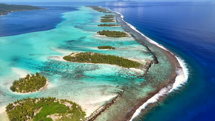 Luxury resort photo of French Polynesia tropical paradise island Taha'a in Pacific Ocean with palm trees. Beautiful photography,  coral reef, azure ocean, aerial view from drone. © TKalinovskaya