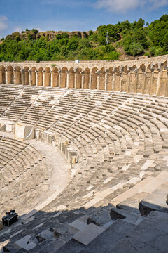 Interior view of the ancient Roman theater at Aspendos with stone seating and stage architecture in Antalya Province, Turkey.